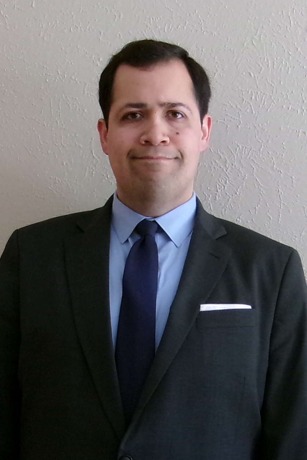 A photograph of Michael Hernandez sharing a friendly smile.