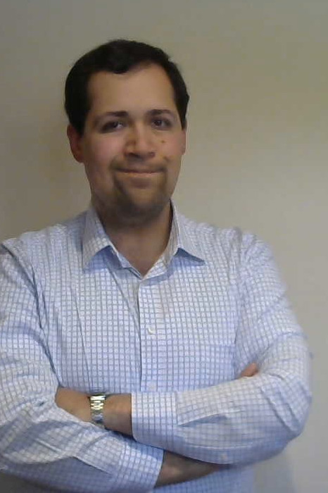 A photograph of Michael Hernandez sharing a friendly smile.